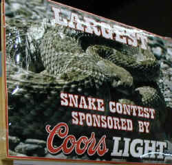 A sign promoting Coors Beer's sponsorship of the Biggest Rattlesnake Contest.