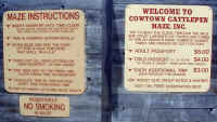 Signage on the Cowtown Cattlepen Maze with instructions and admission cost information.
