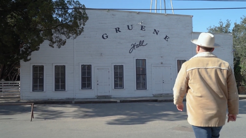 A man walking toward the historic Gruene Hall in Texas