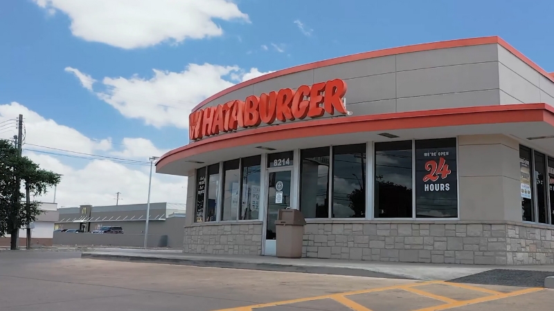Image of a Whataburger location with the sign clearly visible and a 24-hour open notice