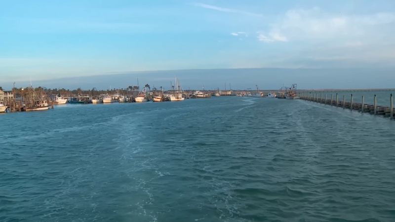 A peaceful view of the waterway and docked boats in Rockport, Texas