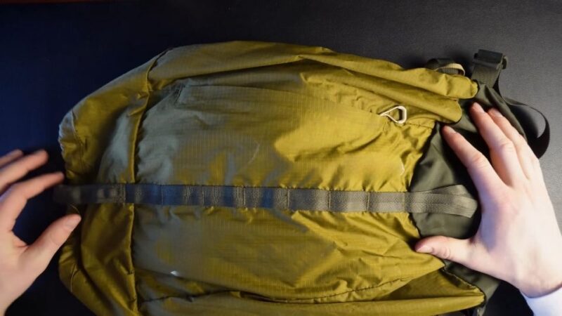 Packed backpack laid out on a surface, showing essentials for a day trip near Lake Austin